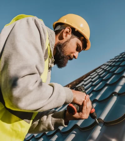 man-working-roof-with-drill-low-view