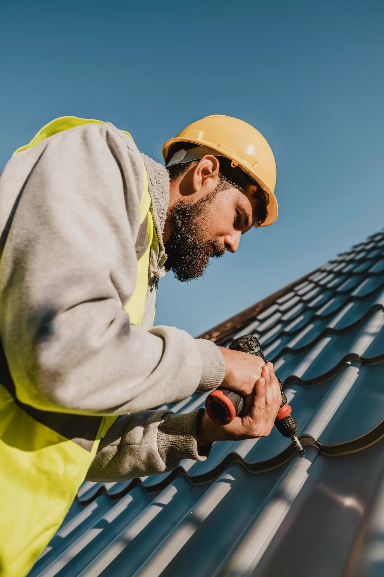 man-working-roof-with-drill-low-view
